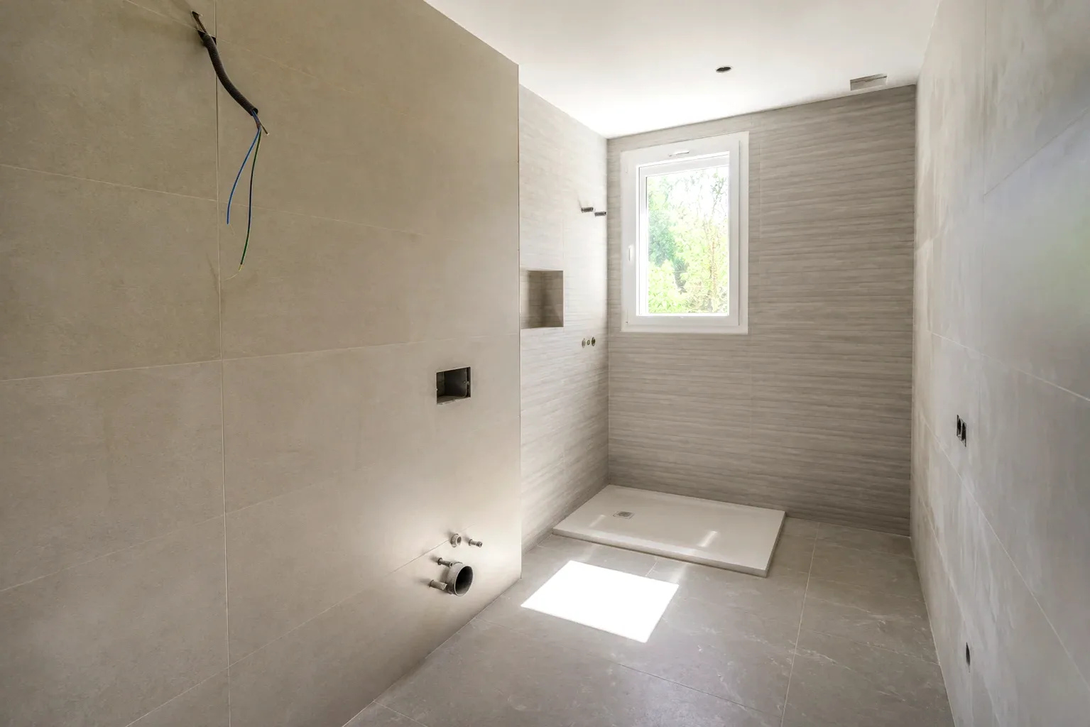 Instalación de plato de ducha durante una reforma de baño en Elda